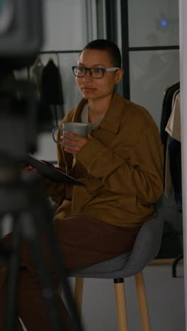 Vertical-Video-Of-Frustrated-Female-Film-Director-Watching-Performance-Of-Actors-On-Monitor-Shooting-Movie-In-Studio-Shot-In-Real-Time